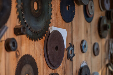 The wall is home to various circular saw blades.