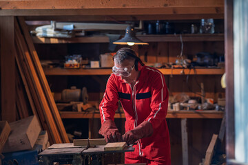 A man prepares to cut a board on a machine.
