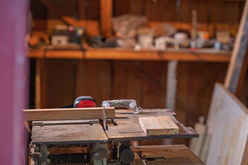 A sawmill with protective equipment lying on it.