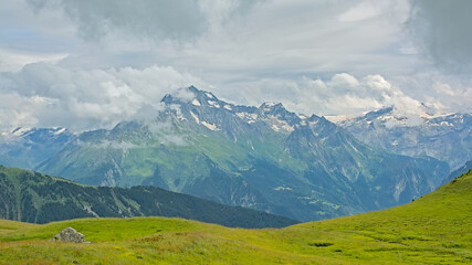 granite mountain peaks with glaciers under a dark stormy sky n La Vanoise national park, Savoie, France
