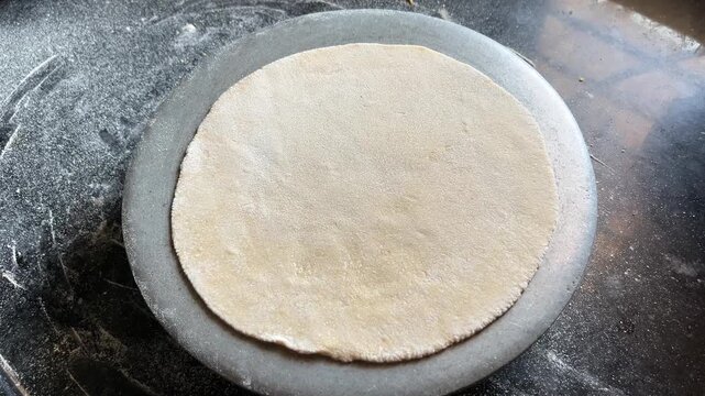 Round Roti Rolled on Chakla | Perfectly Flattened Indian Flatbread Dough on Rolling Board