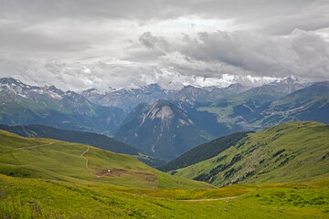 green mountain landscape under a cloudy sky in La Vanoise nature reserve, Savoie, France
