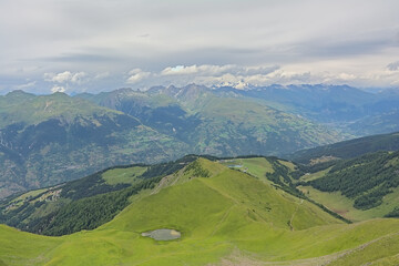 Fototapeta premium green mountain landscape under a cloudy sky in La Vanoise nature reserve, Savoie, France 