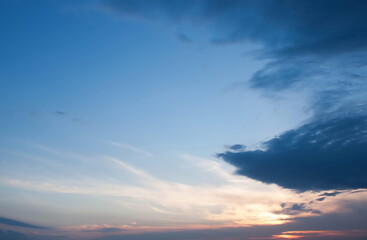 Dramatic Blue Sky with Dark Clouds and Subtle Sunset, Evening Skyscape, Contrast of Light and Shadow, Tranquil Yet Moody Atmosphere, Natural Beauty, Expansive Horizon, Inspiring Outdoor Scene

