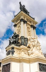 Obraz premium Sculptures at Monument to Alfonso XII in Buen Retiro park, Madrid, Spain