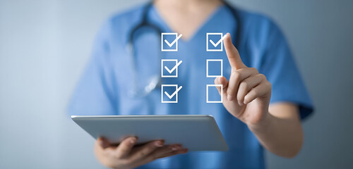 A healthcare professional using a tablet to check off items on a digital checklist in a modern environment.