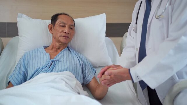 Doctor comforting elderly patient in hospital recovery room.