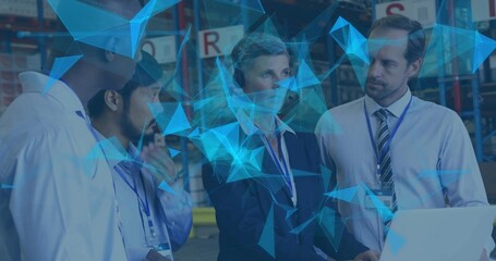 Collaborating logistics professionals using laptop in warehouse, with ID badges and network overlay