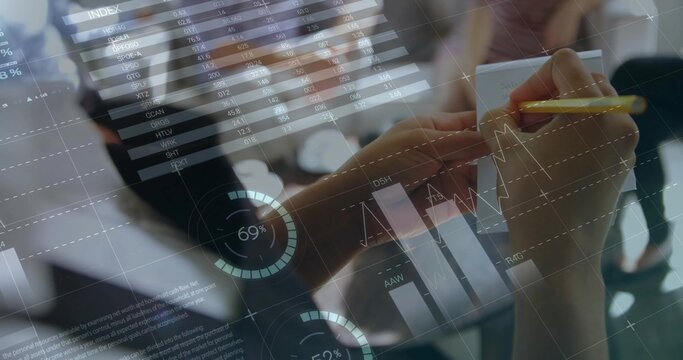 Holding yellow pencil, analyst writing notes on notepad in office, with overlaid financial charts