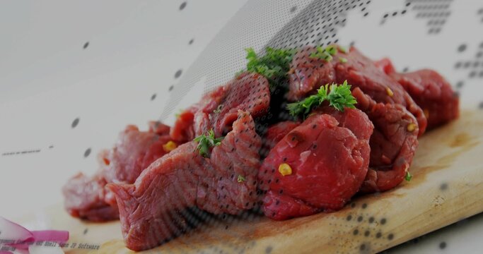 Fototapeta Lying raw beef chunks on wooden cutting board in kitchen with parsley, cracked pepper, onion slices