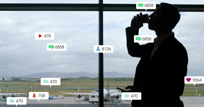 Man holding coffee cup checking phone at airport gate window with jet, notifications, copy space