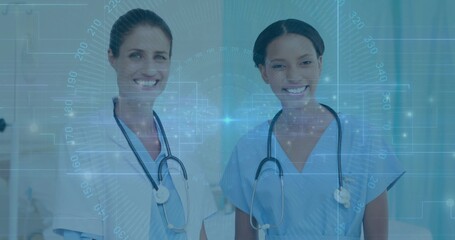 Smiling nurse and doctor showing digital overlay in hospital corridor with scrubs and stethoscopes
