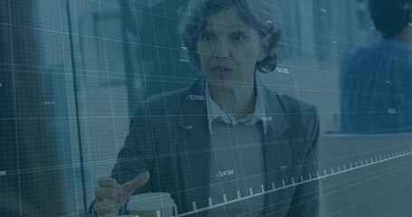 Gesturing businesswoman making point in blazer at office meeting, with coffee cup, data overlay