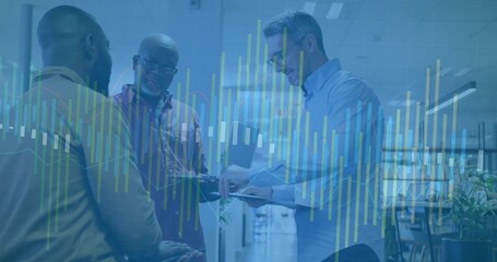 Analyzing three professionals wearing business attire using tablet in office with digital charts