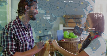 Scanning produce, plaid shirt cashier holding brown bag and scanner at checkout, world map overlay
