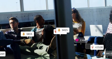 Waiting passengers using laptops and tablet on lounge chairs in airport gate, with AR notifications