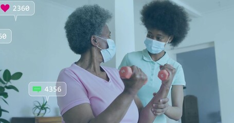 Guiding therapist supporting masked senior woman lifting red dumbbells at home, with overlay icons