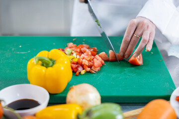 Close-up of chef dicing fresh vegetables