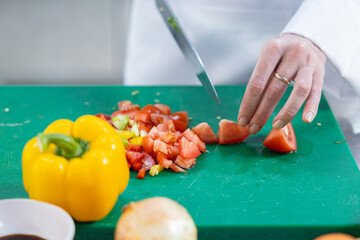 Close-up of chef dicing fresh vegetables