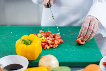 Close-up of chef dicing fresh vegetables