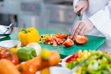 Close-up of chef dicing fresh vegetables