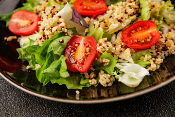 Quinoa salad tomato, green leaf salad vegetables dish natural product tasty snack fresh gourmet food background on the table rustic top view copy space keto and paleo diet vegan and vegan food