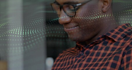 Analyzing digital data overlay at office by man wearing checkered shirt and eyeglasses, copy space