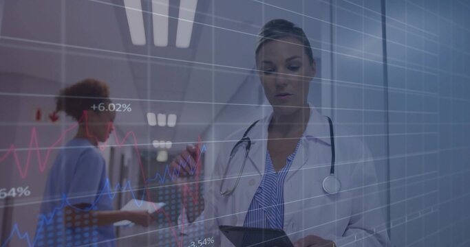 Standing female doctor holding tablet, stethoscope in hospital hall, with chart and digital graphs