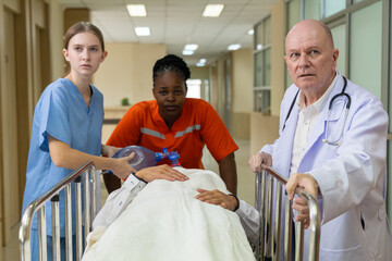 Emergency medical team rushing patient on stretcher