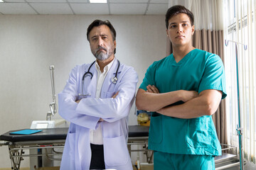 Confident medical team standing in hospital room