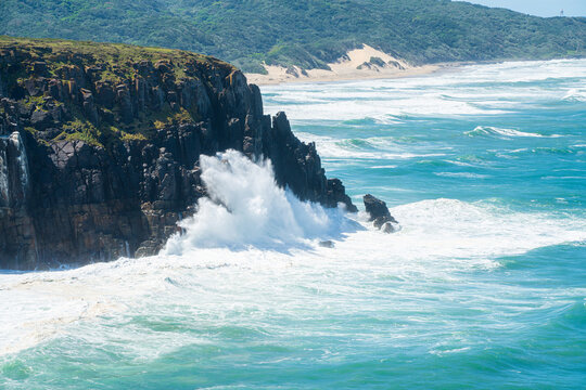 Giant waves crash against the cliffs on the African coast
