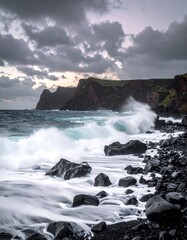 Dramatic view of a rocky coastline pounded by ocean waves beneath a cloudy sky