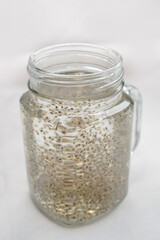Chia seeds water, infused drink contains water, soaked chia seed, help for hydration, healthy food for digestion, rich in omega-3 fatty acids and fiber. Selective focus.