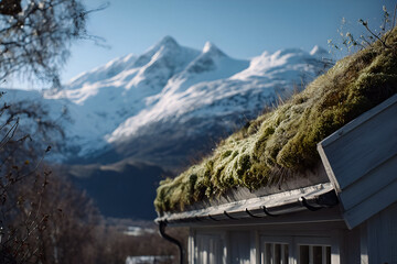 Mountain landscape featuring a traditional building with a green mosscovered roof, surrounded by majestic snowcapped peaks and clear blue sky, creating a serene and picturesque natural environment