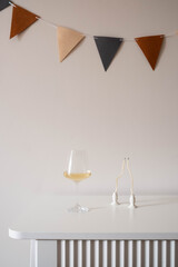 An Elegant Table Setting Featuring Wine Alongside Decorative Bunting for Your Celebration