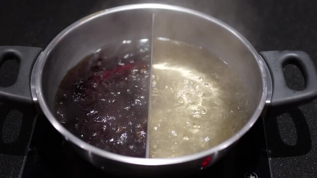 Boiled of combo pot for two flavors of hot pot soup base with lots of steam