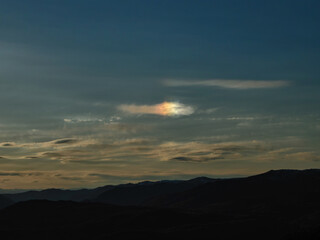 Iridescent Cloud Over Mountain Range