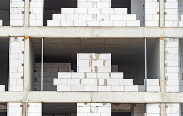The facade of modern residential building under construction