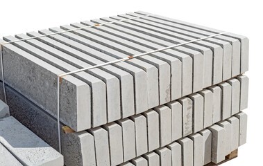 The pallet with a stack of concrete curbstone on white