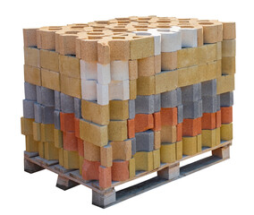 Colorful bricks on wooden pallets on a white