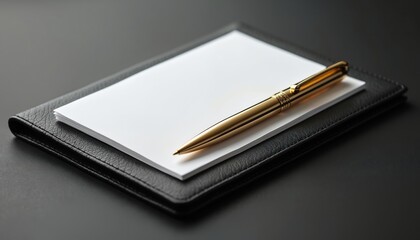 Close up of golden pen on white blank paper lying on dark leather case. Stylish stationery set for business correspondence at modern office table. Template for company branding.