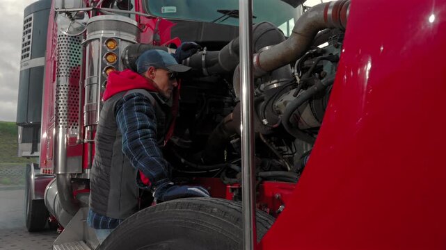Mechanic Working on Truck Engine at Repair Shop