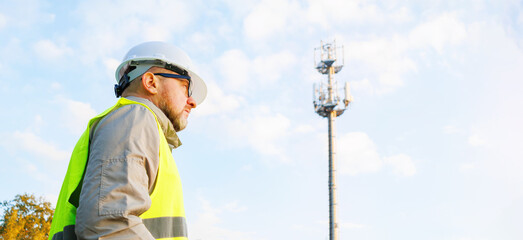 Inspecting 4G and 5G network equipment. Inspection and maintenance of cellular communication poles. Male engineer maintains a telecommunications tower. 