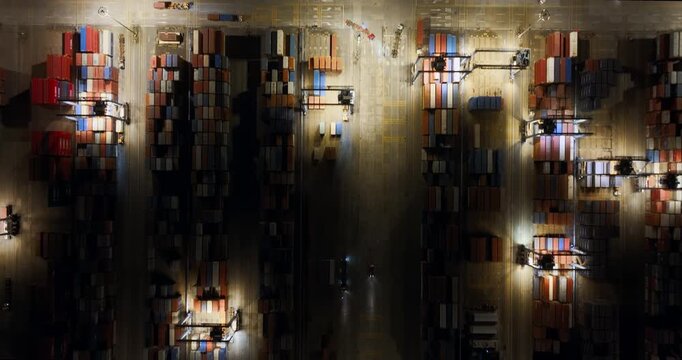 Unloading large cargo containers seaport. Loading freight sea port. Top aerial drone view. Lot big boxes rows, ship delivery ocean harbor. Shipping night. Goods export import. Industrial Marine dock.