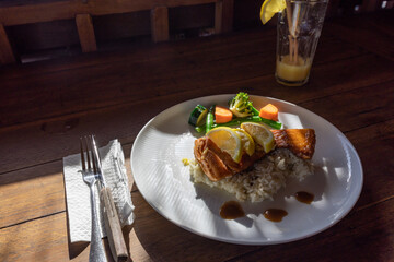 Plate of food with a piece of meat and vegetables on it