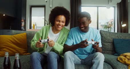 Man and woman having fun playing video games at home - Powered by Adobe