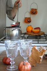 A woman prepares mulled wine. Side view.