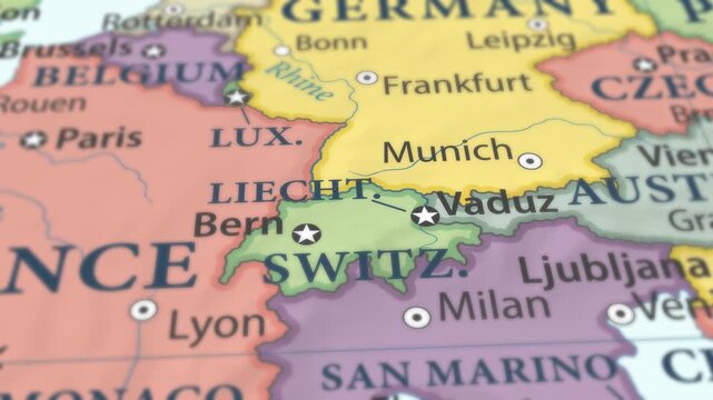 4K macro video of Liechtenstein on a world map with shallow depth of field. Focus on word Liechtenstein and surrounding areas including Switzerland, Austria, and Central Europe. Travel geography foota