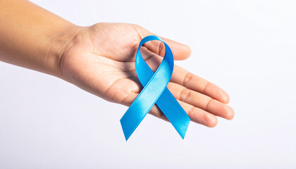 Human hand holding blue awareness ribbon. Child abuse prevention, colon cancer awareness