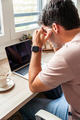 vertical Young man suffering stress teleworking from home
